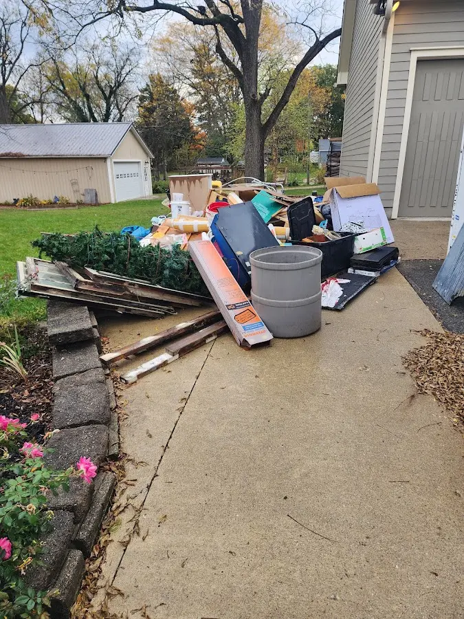 Dumpster being loaded with debris for Roofing Dumpster Rental in Clifton